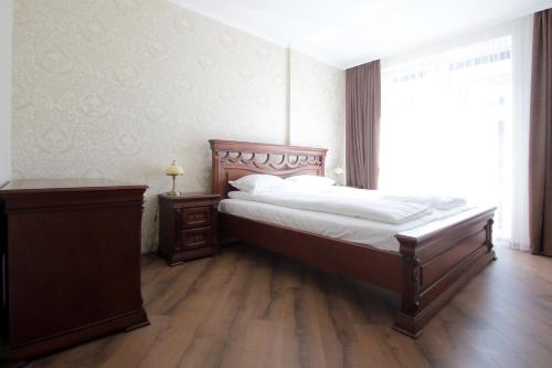 a bedroom with a large bed and a window at Old City apart in Lviv