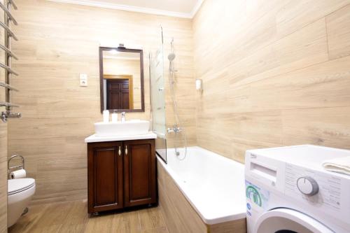 a bathroom with a sink and a toilet and a shower at Old City apart in Lviv
