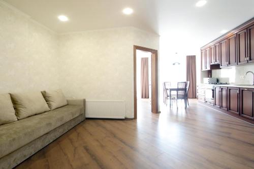 a living room with a couch and a kitchen at Old City apart in Lviv