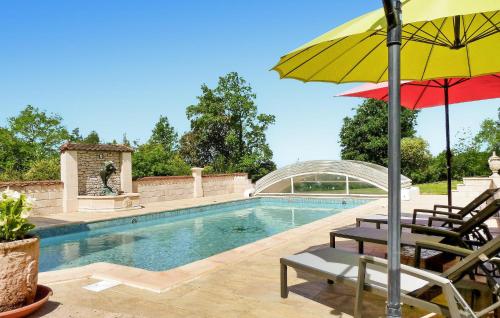 - une piscine avec une chaise et un parasol dans l'établissement La Perle Bleue, à Castelnaud-la-Chapelle