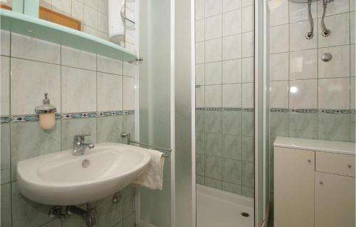 a bathroom with a sink and a shower at Holiday Home Zastrazisce With Sea View 04 in Selca kod Bogomolja