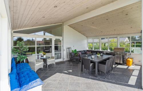 an outdoor patio with a table and chairs at Holiday Home Børkop With Hot Tub Xiv in Børkop