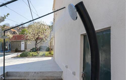 a shower head on the side of a building at Lovely Home In Ramljane in Ramljane