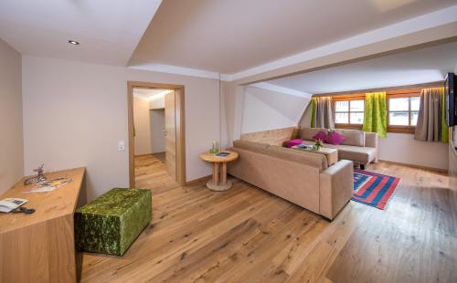 a living room with a couch and a table at Hotel zum Hirschen Zell am See in Zell am See