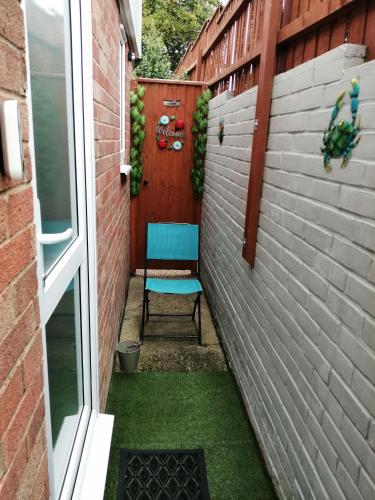 a small patio with a chair in a brick wall at The Blue Crab in Bournemouth in Bournemouth