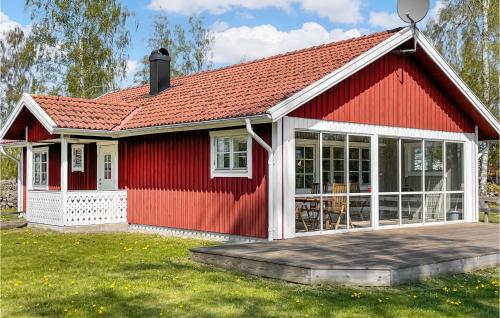 a red cottage with a red roof at 3 Bedroom Nice Home In Vittaryd in Kvänarp