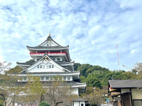 a large white building with a tower on top at Marina Bay Atami in Atami