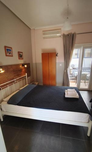a bedroom with a large bed in a room at Garden House Katerina in Leptokaria