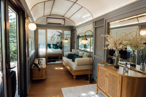 a living room with a couch and a bedroom at LA COCOTTE VILLA & FARM KHAO YAI in Nong Sarai