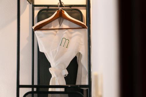a shirt hanging on a hanger in a closet at The Memory - Danang in Da Nang