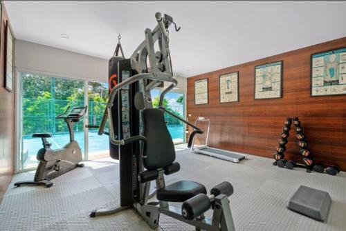 a gym with cardio equipment in a room at MM Villa Koh Samui in Amphoe Koh Samui