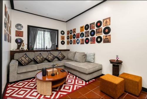 a living room with a couch and a table at MM Villa Koh Samui in Amphoe Koh Samui