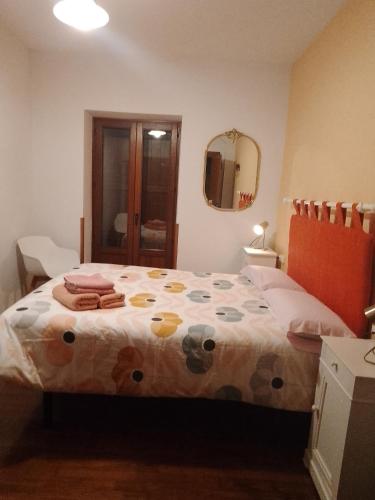 a bedroom with a bed with a polka dot blanket at Casa Rural Juankonogoia in Urrotz