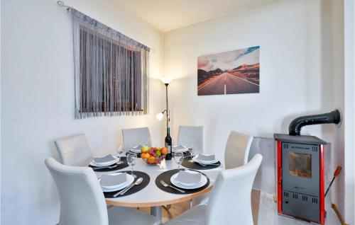 a dining room with a table and chairs and a fireplace at Stunning Home In Gornje Stative in Gornje Stative