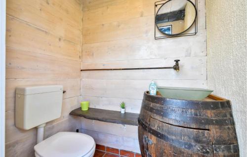 a bathroom with a toilet and a large wooden barrel at Awesome Home In Zagreb With Sauna in Sesvete