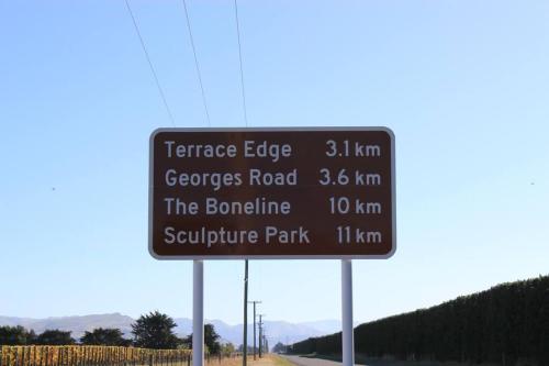a street sign on the side of a road at Olive Grove Cabin Waipara in Waipara