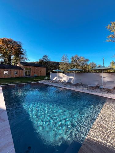 a swimming pool with blue water in a yard at Grange ALMA in Obernai