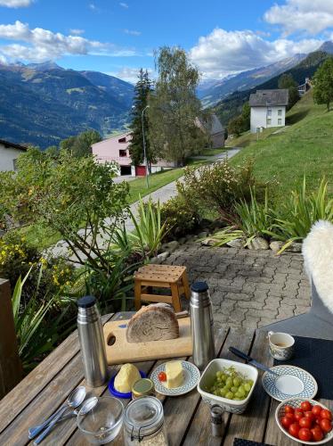 a table with food on it with a view of mountains at Hoch über dem Rheintal in Brigels