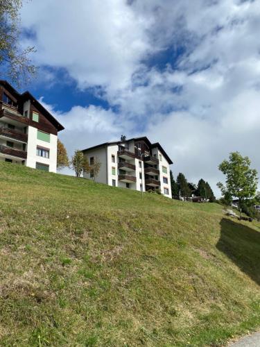 a building on top of a grassy hill at Hoch über dem Rheintal in Brigels