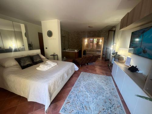 a bedroom with a bed and a living room at Casita Garden&Spa in Carini