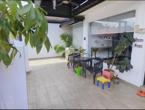 a patio with chairs and a table in a building at Pelita Commercial Centre Homestay 百丽达商圈民宿 9pax in Miri