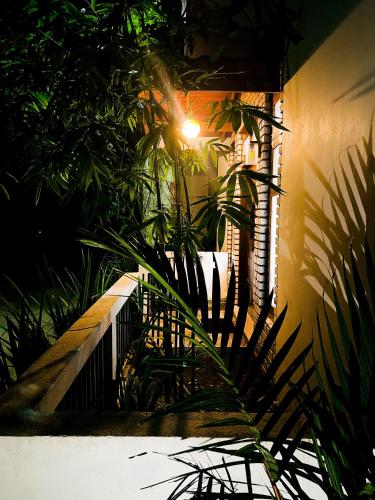 a house with plants and a light on a wall at Enara Luxury Stay in Katugastota