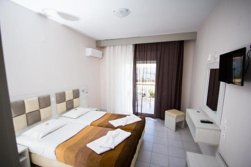 Un pat sau paturi într-o cameră la Hotel Maria