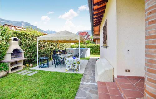 Un patio con una mesa y sillas y una sombrilla. en Casa Nonna Dora, en Camaiore