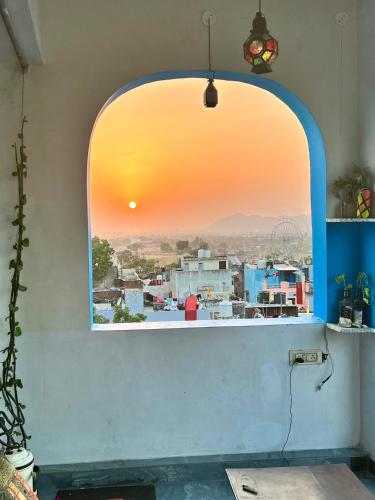 an arched window with a view of a city at Suri Guest House in Pushkar