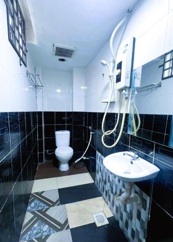 a bathroom with a toilet and a sink at ARK Ampang Tesco Hotel in Kuala Lumpur
