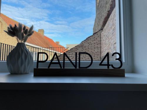 a window with a vase on a window sill at Pand 43 in Diksmuide