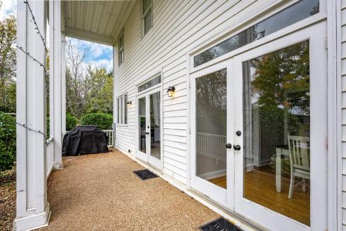 a porch of a white house with glass doors at Colonial Manor in Spring Hill