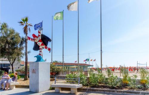 a park with a bench and flags on the beach at Gorgeous Home In Viareggio With Kitchen in Viareggio