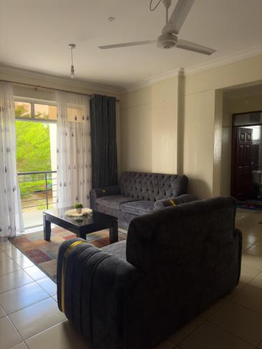 a living room with a couch and a table at Hillsview Apartment in Voi