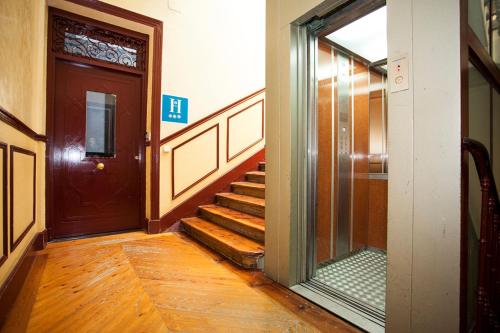 a hallway with a door and stairs in a building at Alhambra Suites in Madrid