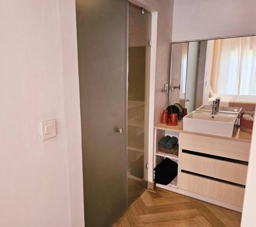 a bathroom with a sink and a mirror at Seaside 3 suites Penthouse with Pool Gym & BBQ Terrace in Cap Malheureux