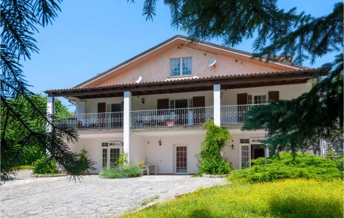 a large white house with a balcony at Casa Glicine in Pian di Mulino