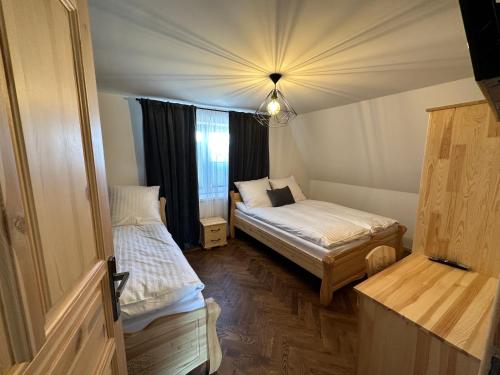 Postel nebo postele na pokoji v ubytování Apartamenty u Mocarnego