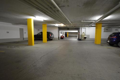 an empty parking garage with cars parked in it at Ferienwohnungen Chesa Clois 24 Studios in Lenzerheide