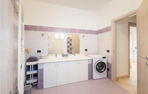 a bathroom with a sink and a washing machine at 2 Bedroom Nice Home In Borgo D'oneglia in Borgo dʼOneglia