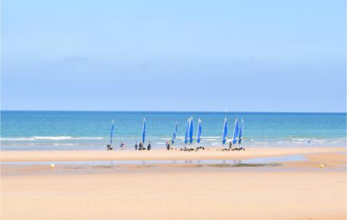 a group of people on a beach with blue flags at Awesome Home In Colombieres With Wifi in Colombières