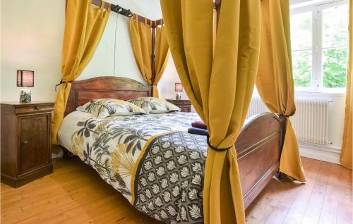 a bedroom with a bed with yellow curtains at Awesome Home In Colombieres With Wifi in Colombières