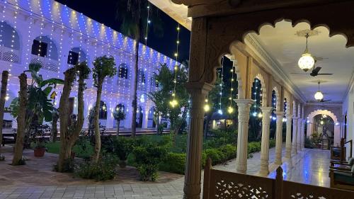 a building with christmas lights and trees in it at Hotel Sunbird in Bharatpur