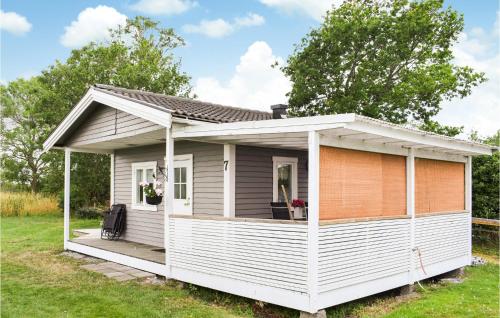 a white tiny house with a porch at 3 Bedroom Lovely Home In Borgholm in Borgholm