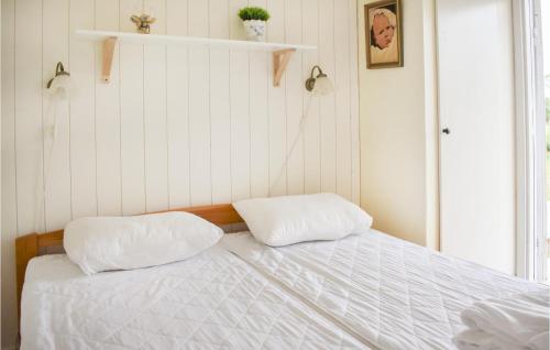two white pillows sitting on top of a bed at 3 Bedroom Lovely Home In Borgholm in Borgholm
