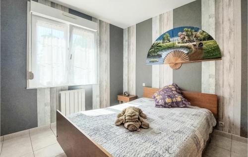 a stuffed animal sitting on a bed in a bedroom at Lovely Home In Quoux-Haut-Maînil in Haut-Maînil