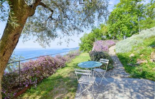 a table and two chairs sitting on the side of a hill at S Rocco Dimora Tra Ulivi E M in Zoagli
