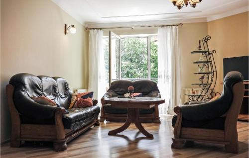 a living room with two leather chairs and a table at Cozy Apartment In Kolobrzeg With Wifi in Kołobrzeg