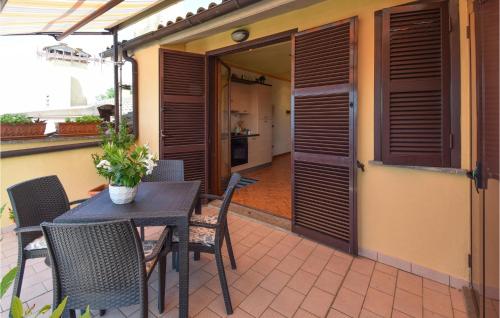 a patio with a table and chairs and a kitchen at Stunning Apartment In Montefiascone in Montefiascone