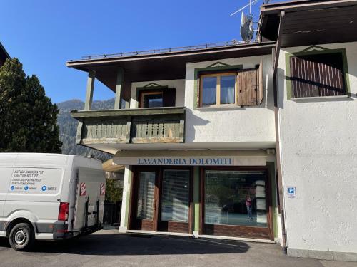 a white van parked in front of a building at 010 Trilocale Quadrifoglio, Pinzolo in Giustino